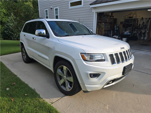 Jeep Grand Cherokee parked in driveway.