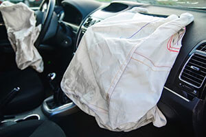 view of driver and passenger deployed airbags