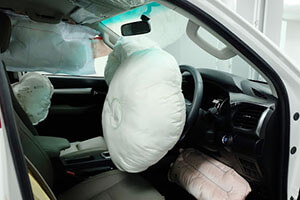 the interior of the front of the car with all the airbags deployed