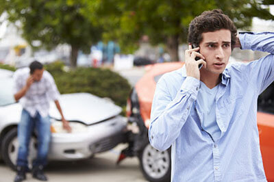 worried man talking on the phone after an accident