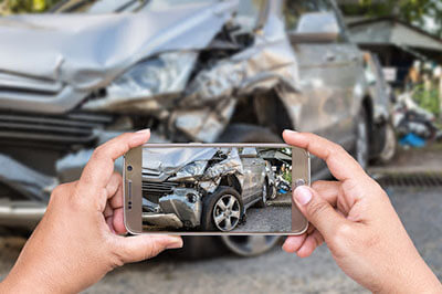 taking a picture of a damaged car with the phone