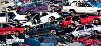 discarded cars stacked on top of each other